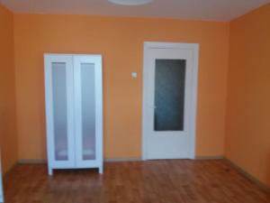 an empty room with orange walls and a white door at Apartment in Pašilaičiai. Self check-in. Parking in Vilnius