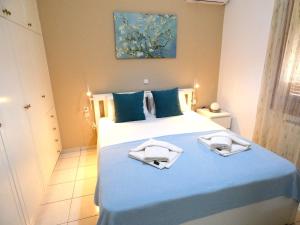 - une chambre avec un grand lit et des serviettes dans l'établissement Mel Studio 2 (kalamaki), à Kalamaki