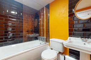 a bathroom with a sink and a toilet and a tub at Kiri Cottage Hawkridge in Dulverton +33 photos