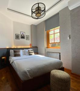 a bedroom with a large bed and a window at GalataCo Hotel in Istanbul