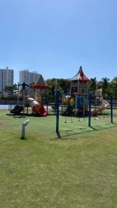 a playground with slides and play equipment in a park at Exclusivo, Moderno y Cómodo Apto temático con hermosa Vista al Mar in Playa Blanca