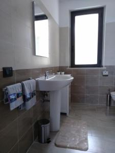 a bathroom with a white sink and a window at Viamediterraneo392 Casa Vacanze in Petacciato