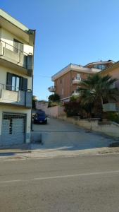 a car parked in a parking lot next to a building at Viamediterraneo392 Casa Vacanze in Petacciato +3 photos