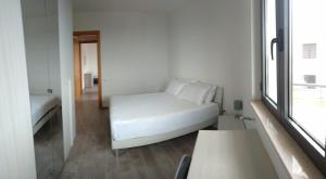 a white couch in a room with a window at Viamediterraneo392 Casa Vacanze in Petacciato