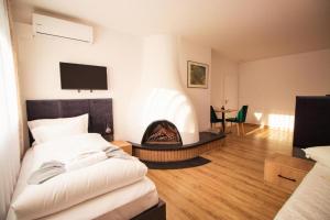 a bedroom with a bed and a fire place at Hotel Dona in Bergisch Gladbach