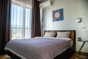 a bedroom with a bed with a large window at The Dream Getaway & Spa by DeVasco in Becici