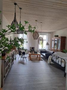 a large living room with a bed and a couch at Apartament w Fabryce Czekolady in Bytom