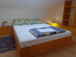 a bedroom with a bed with a wooden frame at Apartmani Marina in Labin