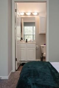 a white bathroom with a sink and a toilet at Corporate Housing by MGM in Gurnee