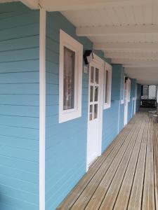 a porch of a house with blue and whiteiding at Resort Camping Santillana del Mar in Santillana del Mar