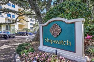 a sign in front of a building with flowers at 1379 Shipwatch in Amelia Island