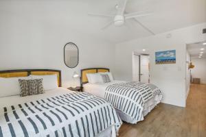 a bedroom with two beds and a ceiling fan at 1379 Shipwatch in Amelia Island