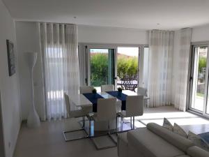a living room with a blue table and chairs at Silver Coast Holiday in Salir de Porto