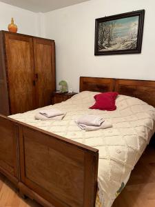 a bedroom with a large bed with two towels on it at Emese Central Vintage Apartment in Târgu-Mureş