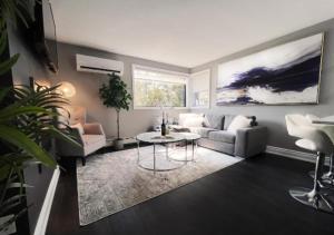 a living room with a couch and a table at Elegant City Living - 1 BR in London +1 photo
