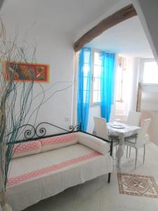 a living room with a couch and a table at Sardinia Yellow House in Solanas +37 photos