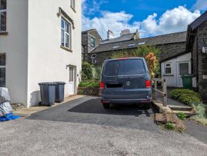 a van parked in the driveway of a house at Weavers Two - Luxury Apartment for Two in Windermere
