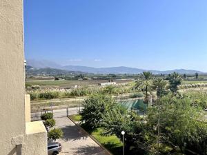 a view from a balcony of a building with a parking lot at Ático con terraza y barbacoa in Salobreña