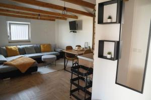 a living room with a couch and a table at Apartman River in Belišće