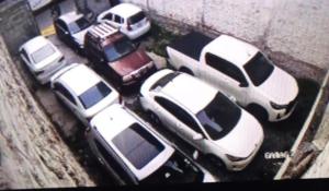 a group of parked cars in a parking lot at HOTEL MADURAI in Ambato