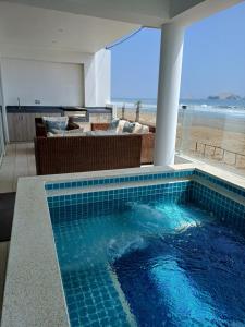 a swimming pool with a view of the beach at 202 Urban Beach in Lurín