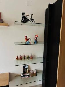 a shelf with figurines and a bike on it at Prem-Nikunj प्रेम-निकुंज in Vrindāvan