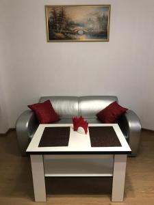 a living room with a couch and a table at Light Apartments in Chernihiv