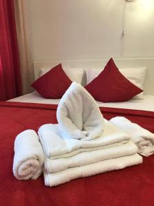 a pile of towels sitting on top of a bed at Light Apartments in Chernihiv +25 photos