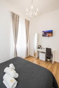 a bedroom with a bed and a chandelier at Room 23 in Rome