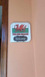 a sign on a wall that reads the red dragon welcome at The Red Dragon in Dassia