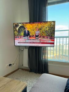 a flat screen tv on a wall in a room at Sweet dreams Porvoo 2 in Porvoo