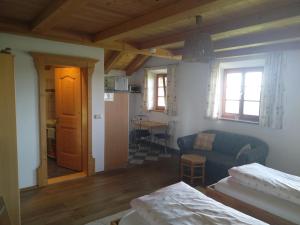 a living room with a couch and a dining room at Arbeiterwohnung Entbuchner Hof in Rohrdorf