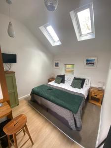a bedroom with a bed and skylights on the ceiling at Claremont House Keswick in Keswick