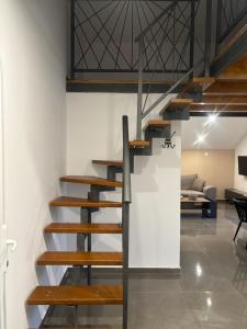 a staircase in a loft with a living room at Studio Apartmani Sladakovic in Kistanje