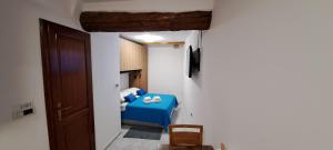 a small room with a blue bed and a door at Studio Arsenale 7 in Rovinj