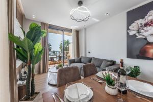 a dining room with a table and a couch at Amazing beachfront Oasis in Durrës
