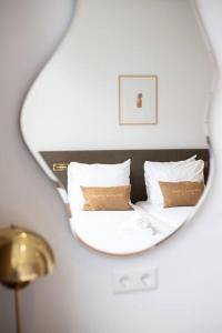 a mirror reflection of a bed in a hotel room at Anegang Boutique Hotel in Haarlem