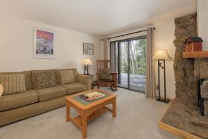 a living room with a couch and a fireplace at Beaver Village Unit #0712R in Winter Park