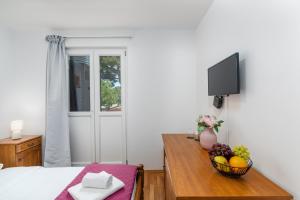 a bedroom with a table with a bowl of fruit on it at Laco Rooms in Novigrad Istria