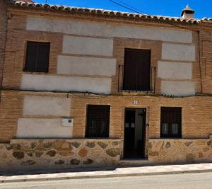 a brick building with windows and a door at Casa La Calera in Cobisa