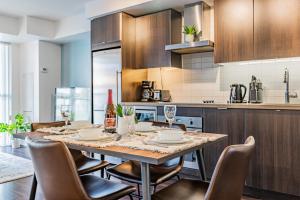 a kitchen with a dining table and chairs in a kitchen at 300 Front Suites in Toronto