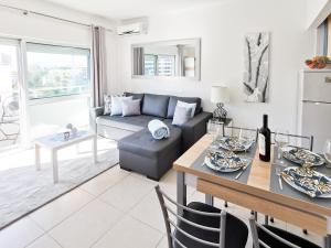 a living room with a couch and a table at Apartment Panorama Rocha Capri in Portimão