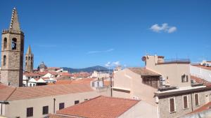 a view of a city with a church and roofs at Casa Mirto in Alghero