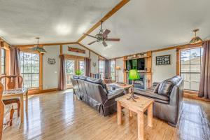a living room with two leather couches and a table at Peaceful Ruidoso Cabin Hot Tub, Mountain Views! in Ruidoso