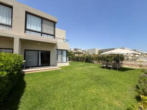 a yard in front of a building with a lawn at Azha Luxury vacation villa Ain sokhna - families only in Ain Sokhna