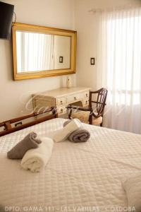 a bedroom with a bed with a mirror and a desk at Departamento GAMA 111. in Las Varillas