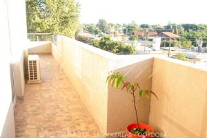 a plant in a pot sitting on a balcony at Departamento GAMA 111. in Las Varillas