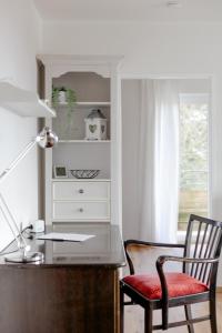 a desk with a chair next to a dresser at Ferienwohnung Parkblick in Bad Herrenalb