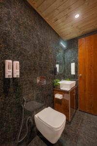 a bathroom with a toilet and a sink at The Kufri Retreat I Vacations I Conference I MICE I Family Events I Open Air Terrace I Sky Bonfire I Wooden Rooms With Pvt Balconies I by Exotic Stays in Shimla