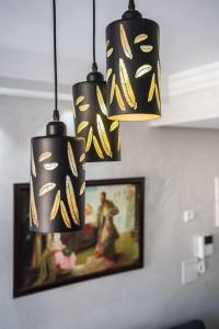 three black and gold lights hanging from a room at Chic Apartment Cosy Stay in Casablanca